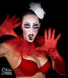 A colorful face paint model in red