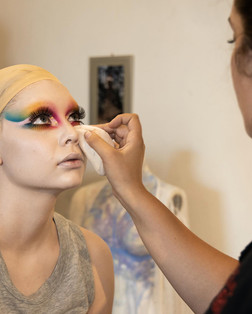 A make up artist applying abstract make up to a model