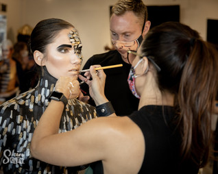 A make up stylist applying make up to a model